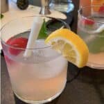 vodka strawberry lemonade cocktail with a lemon mint and strawberry garnish