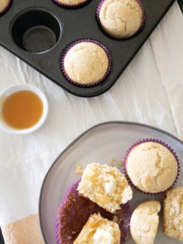 corn muffins on a plate with a side of honey