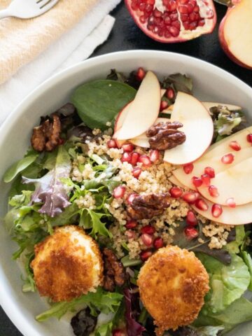 fall salad topped with fried goat cheese balls