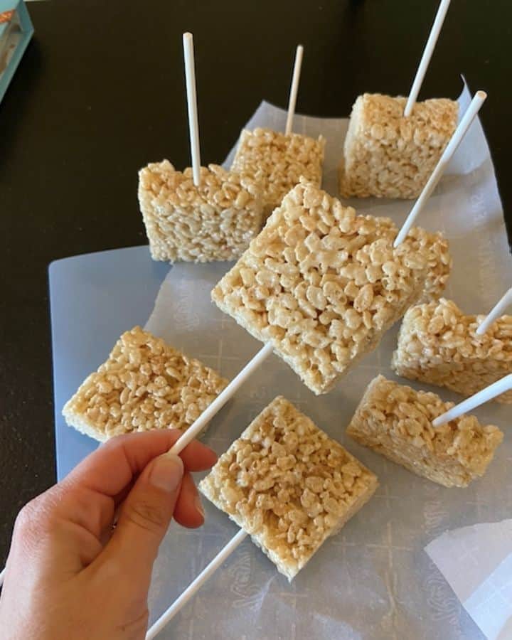 rice krispie on a stick held by a hand