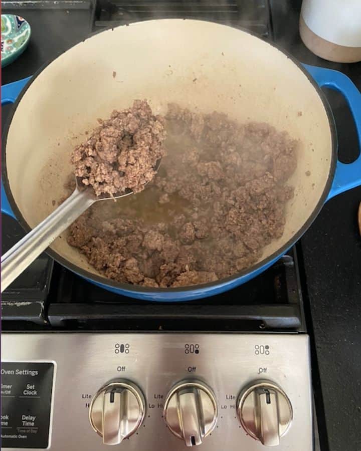 straining meat with a spoon