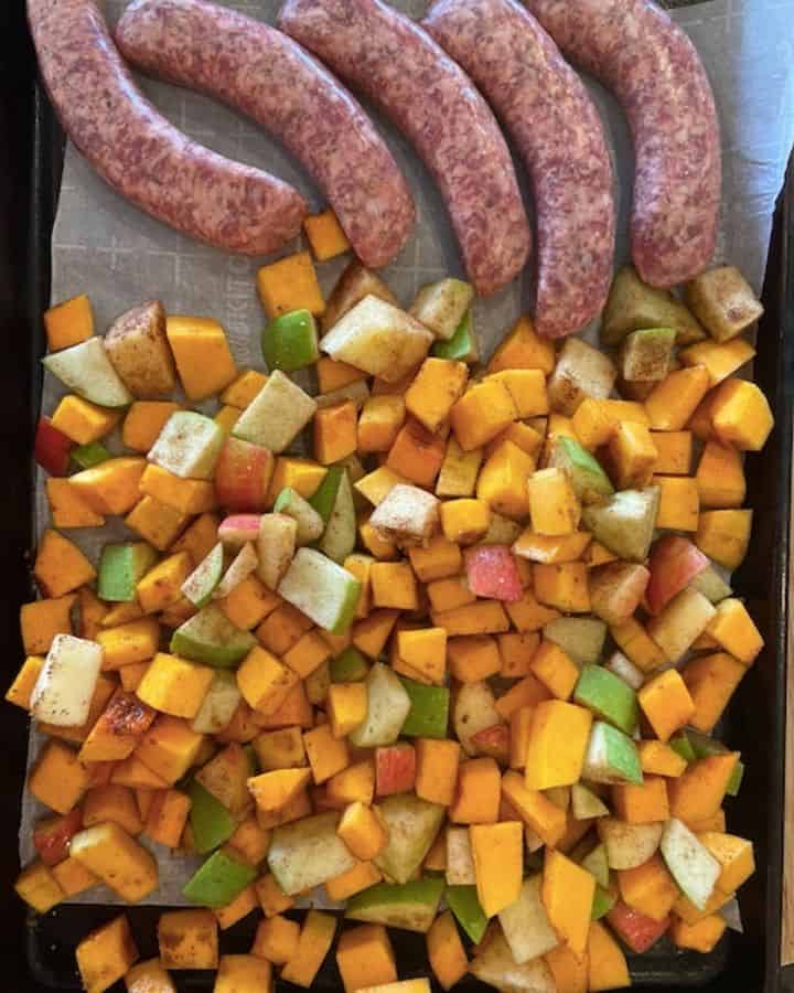 sausage and butternut squash and apple mixture on cookie sheet