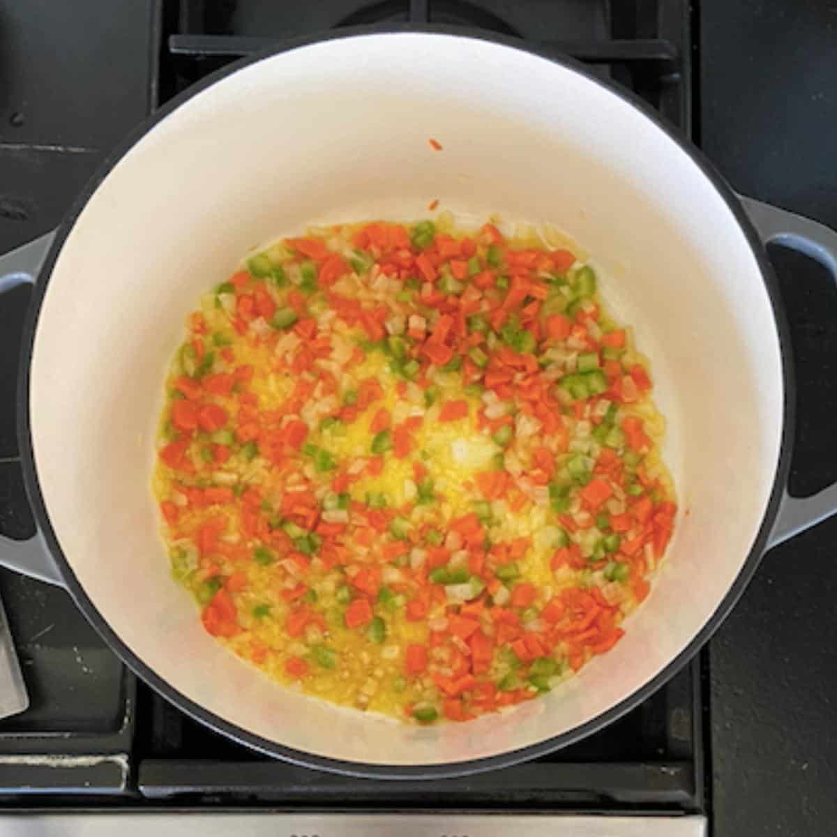 butter and vegetables cooking in dutch oven