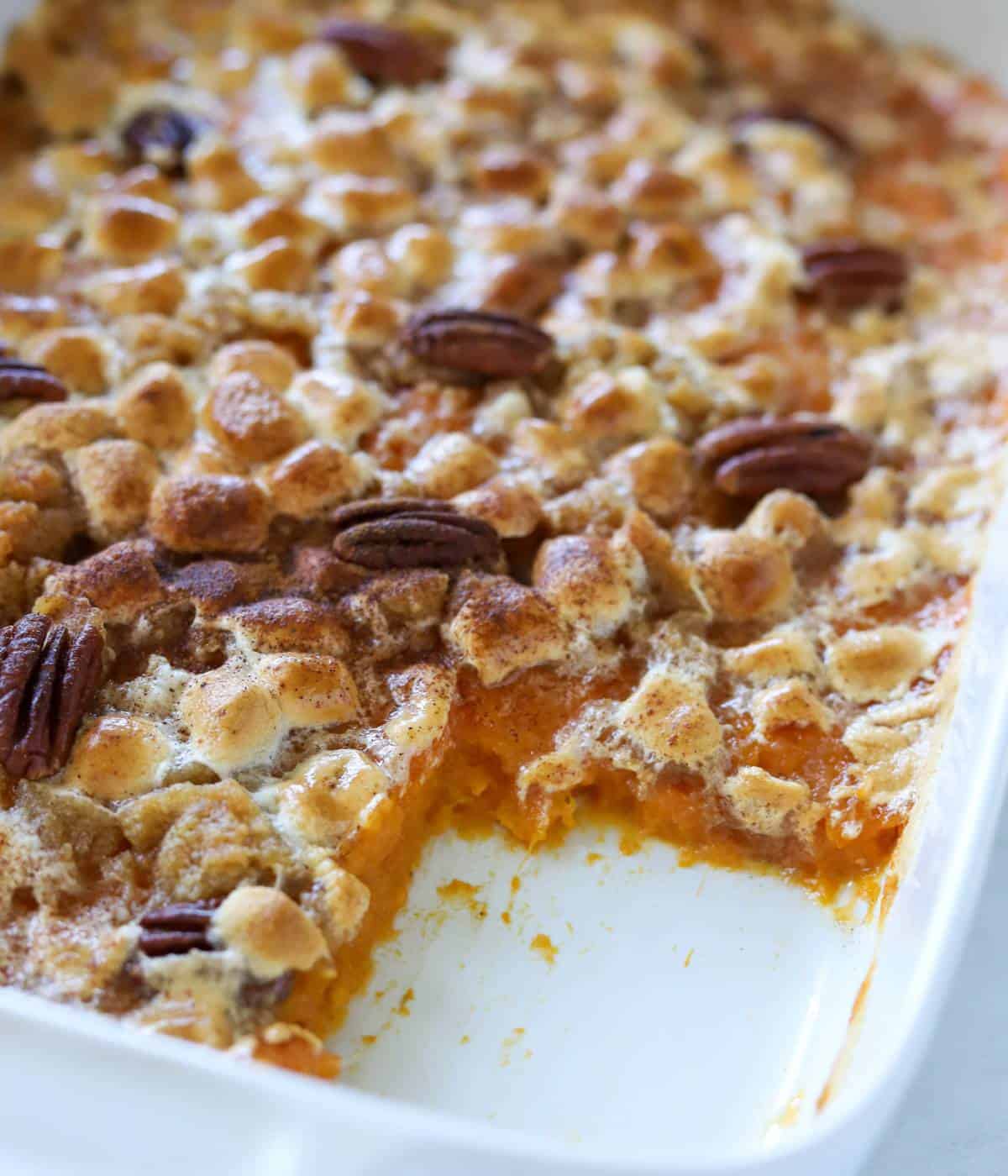 Sweet potato casserole in dish with one slice missing. 