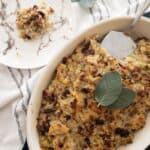 cornbread dressing with sausage in casserole dish topped with sage