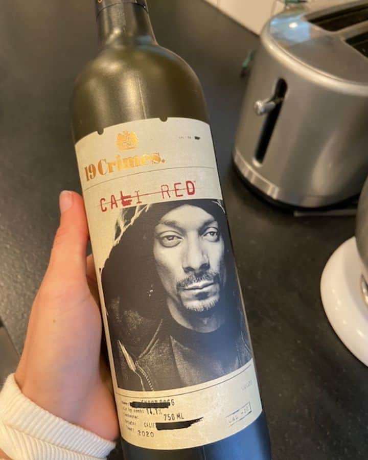 hand holding bottle of snoop dog cali red wine by 19 crimes