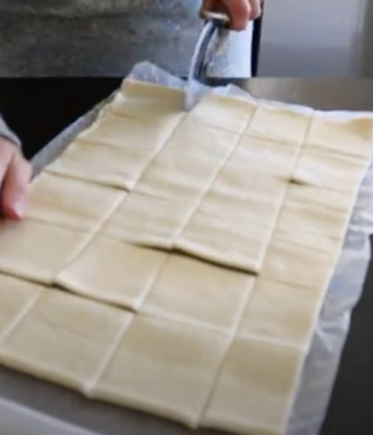 Puff pastry sliced into 24 squares with pizza cutter. 