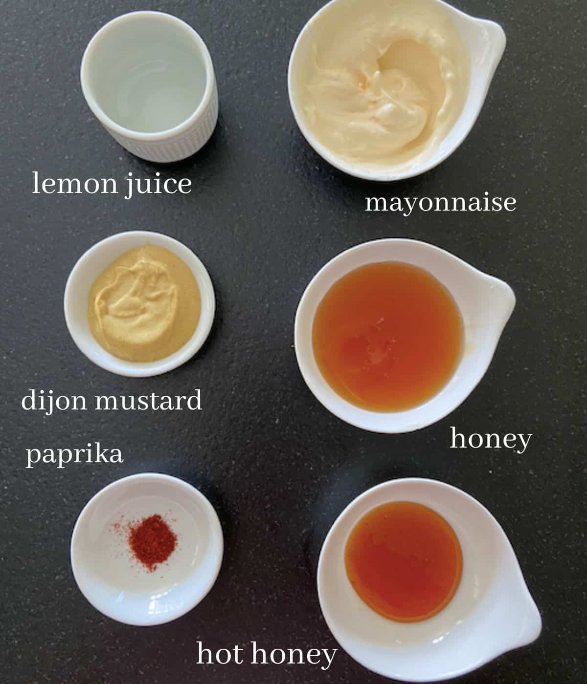 Ingredients for hot honey mustard on black countertop
