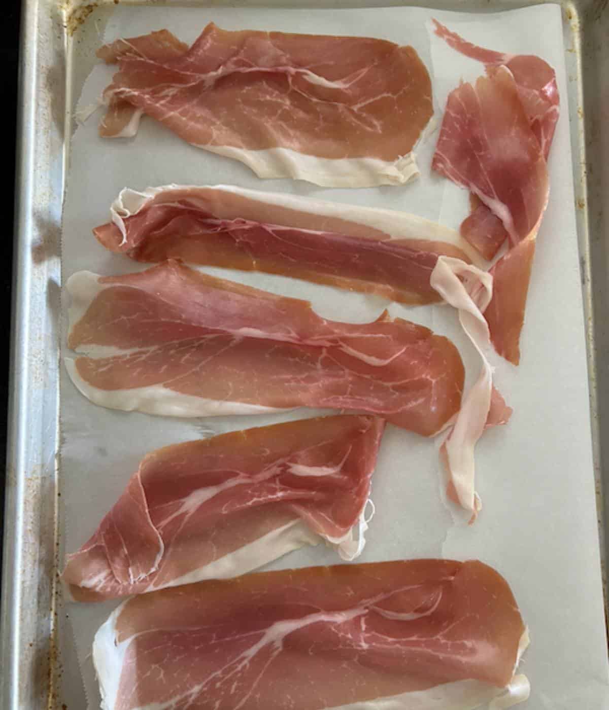 Prosciutto on cookie sheet.