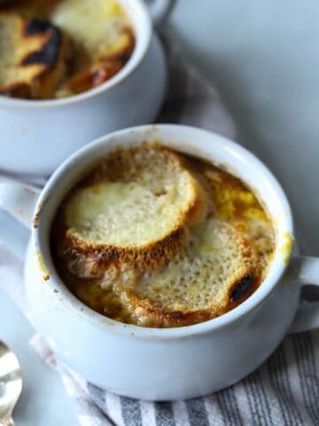 French onion soup in soup bowl with bread and cheese.