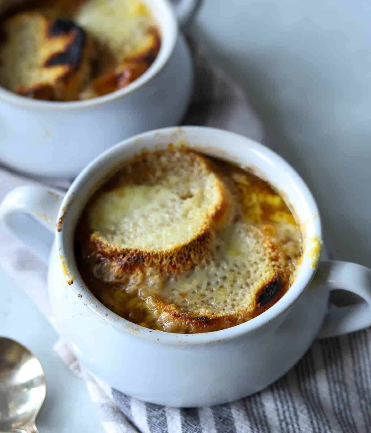 French onion soup in soup bowl with bread and cheese. 