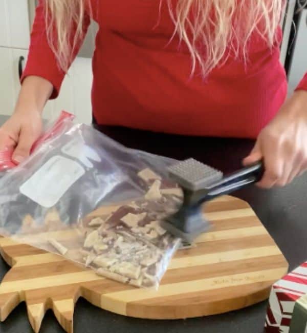 mallet crushing peppermint chocolate squares in ziplock bag
