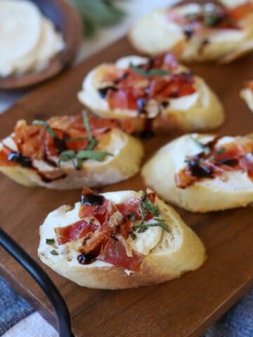 Crostini topped with goat cheese, prosciutto and sage.