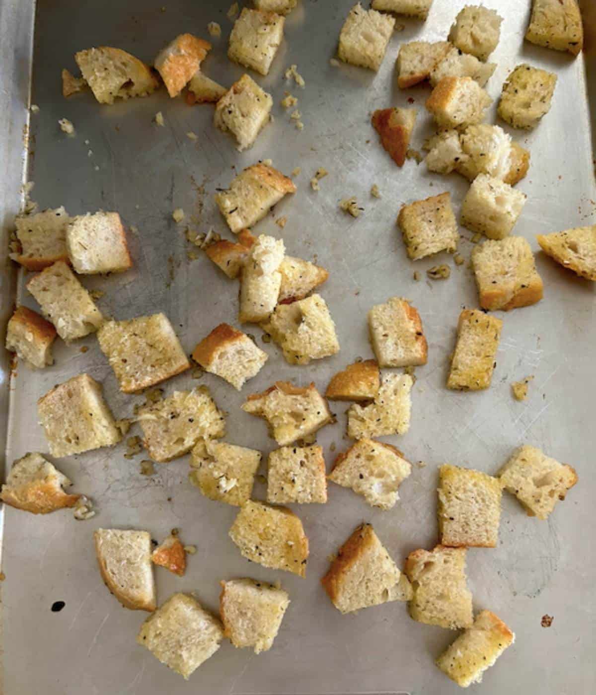 Soup croutons tossed in garlic butter on cookie sheet.