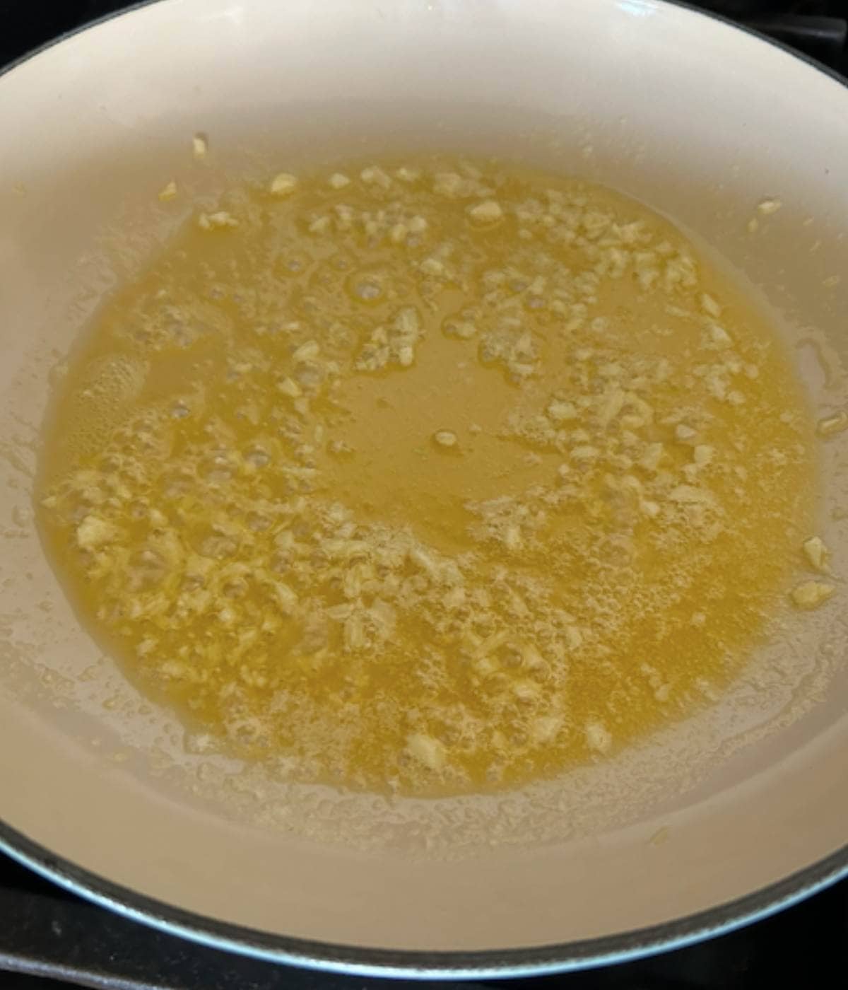 Garlic butter melting in pan.
