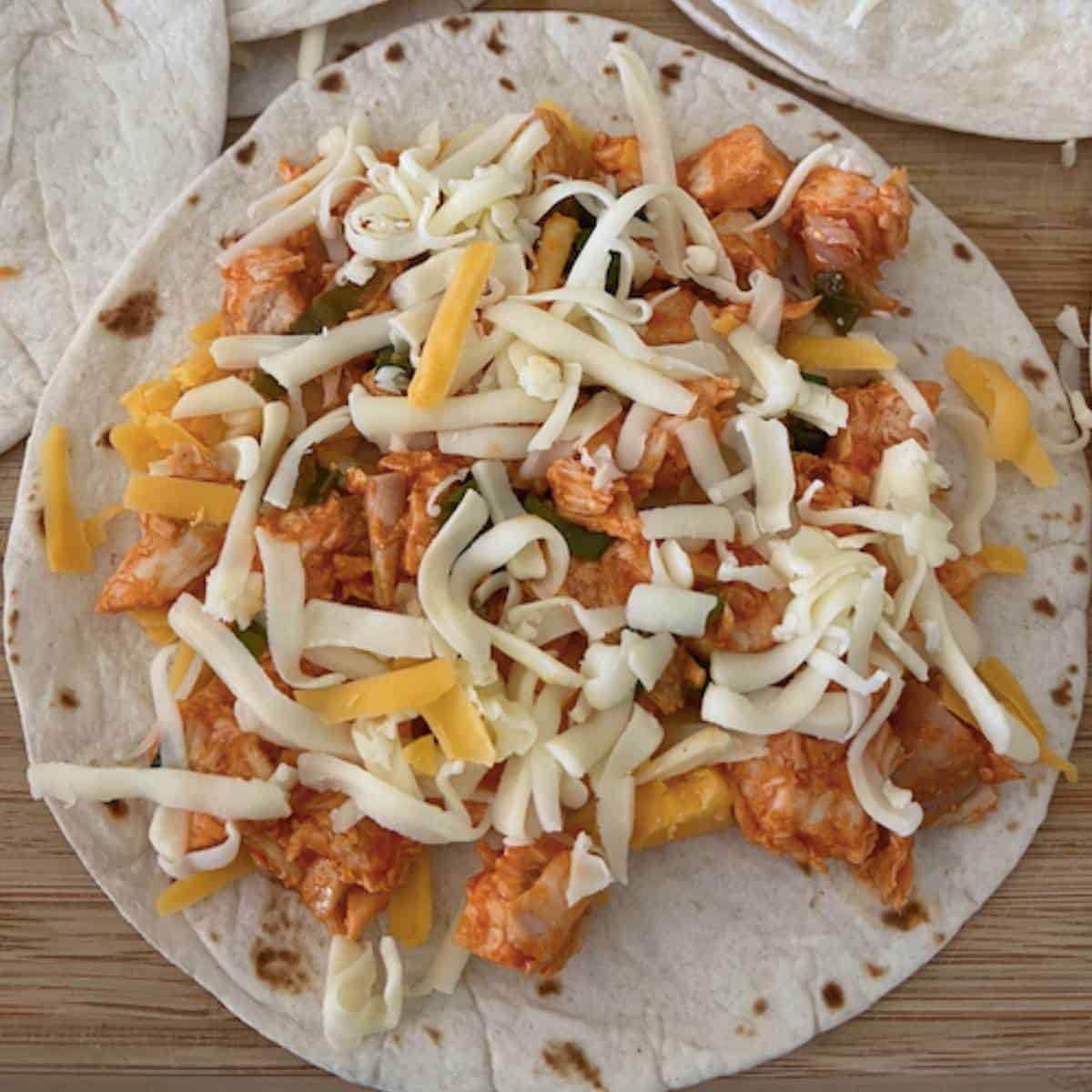 flour tortilla topped with buffalo chicken and cheese