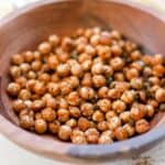 close up of chili lime sautéed chickpeas in wooden bowl