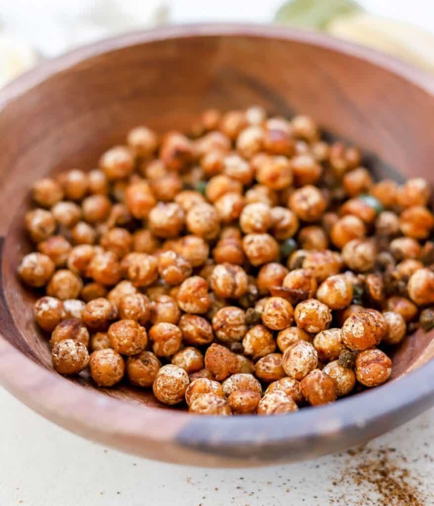 close up of chili lime sautéed chickpeas in wooden bowl