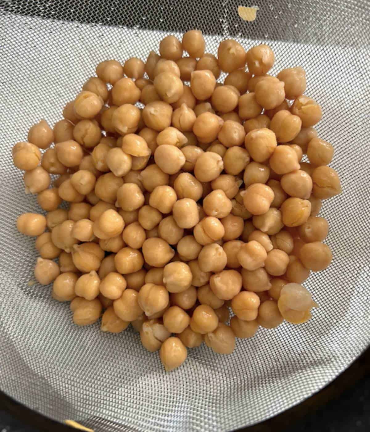 Drained and dried chickpeas in colander.