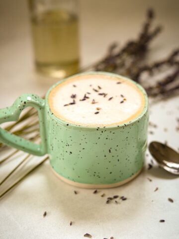 hot lavender latte in blue speckled coffee mug