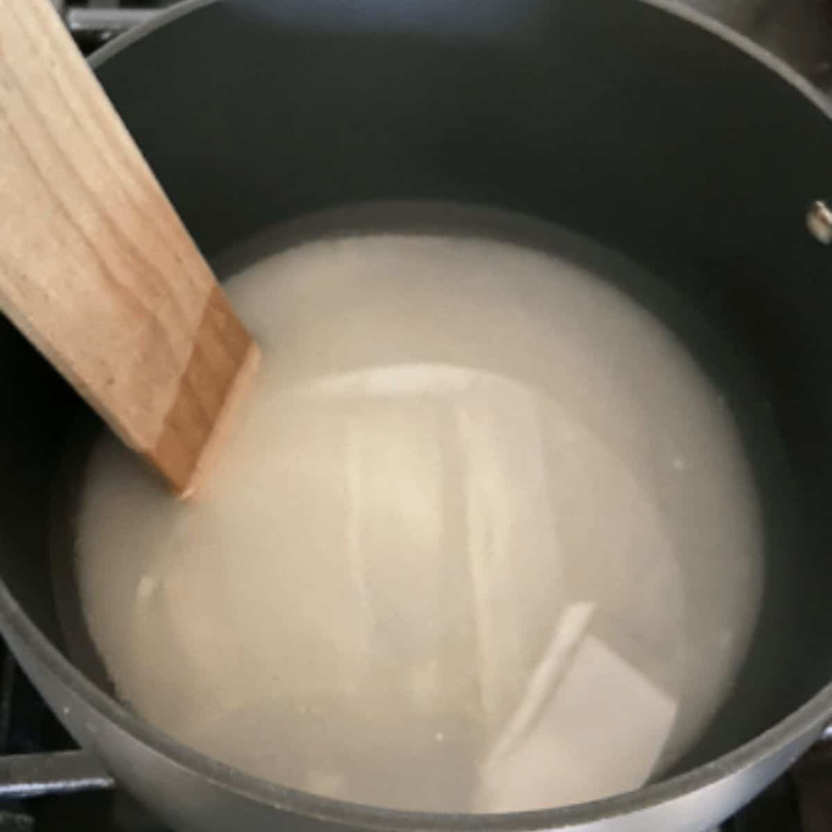 Sugar and water in pot.