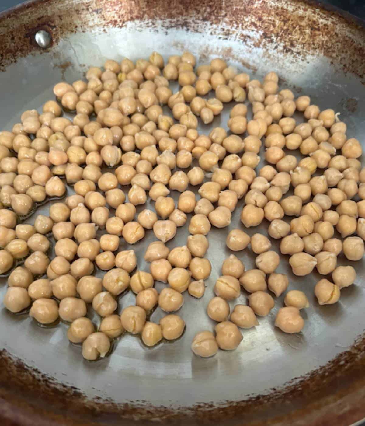 Chickpeas toasted in oil in skillet.