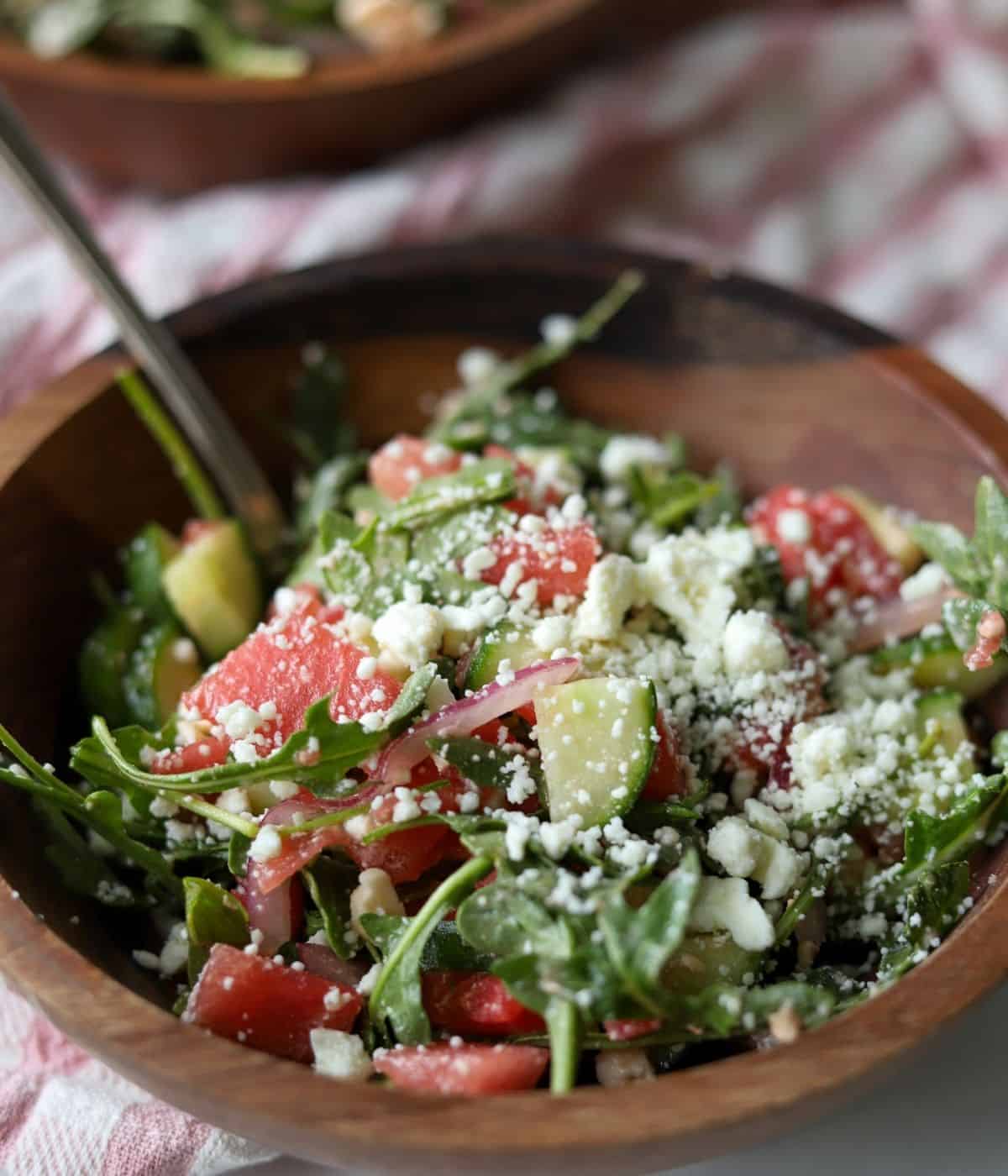 watermelon arugula and feta salad in wooden bowl