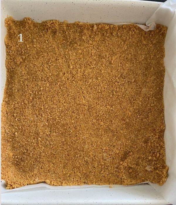 graham cracker crust packed into 8x8 pan