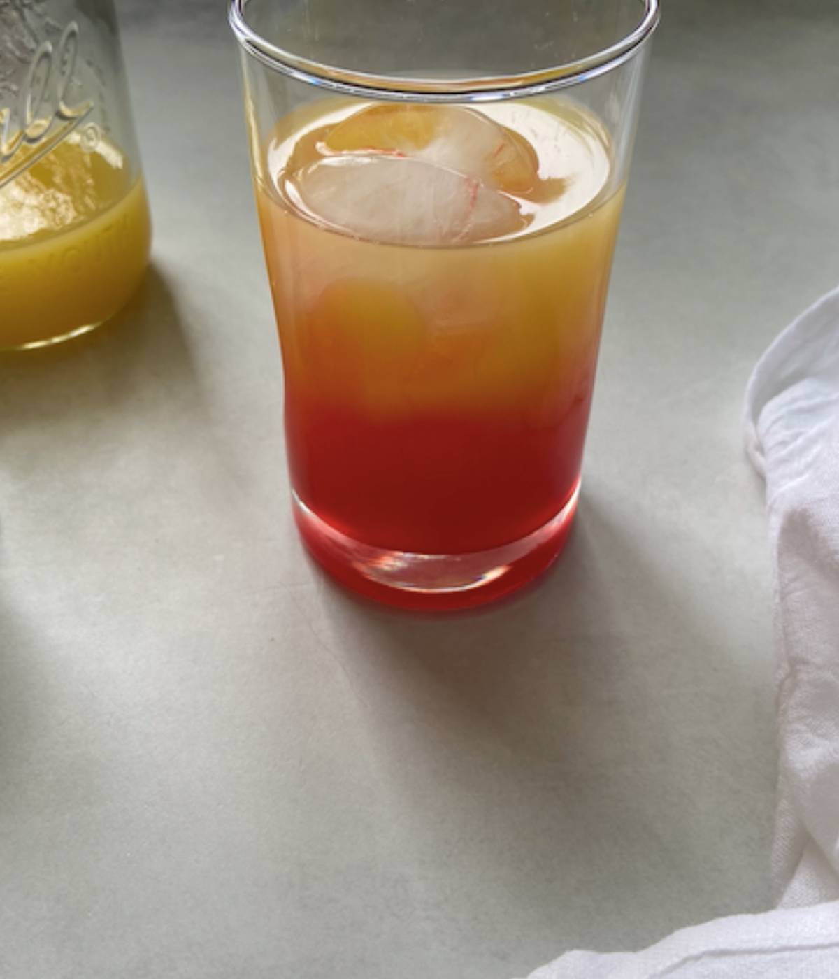 Grenadine added into cocktail glass to finish drink.