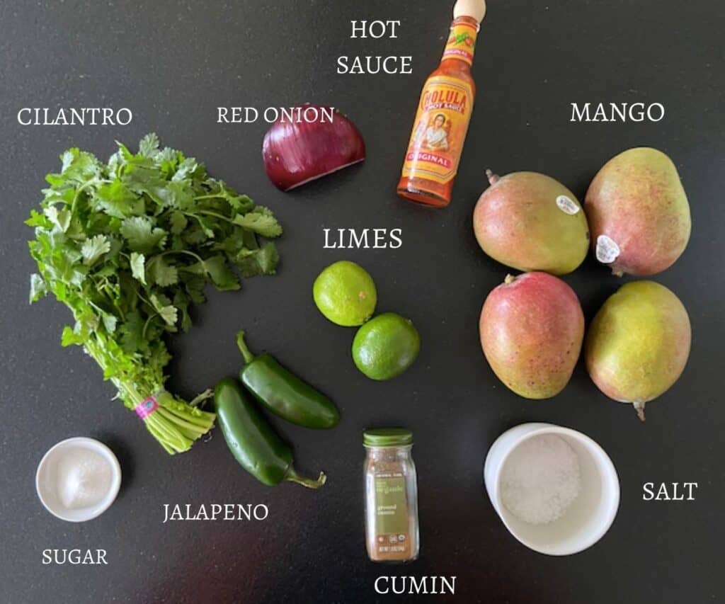 ingredients for mango pico de gallo on table with text