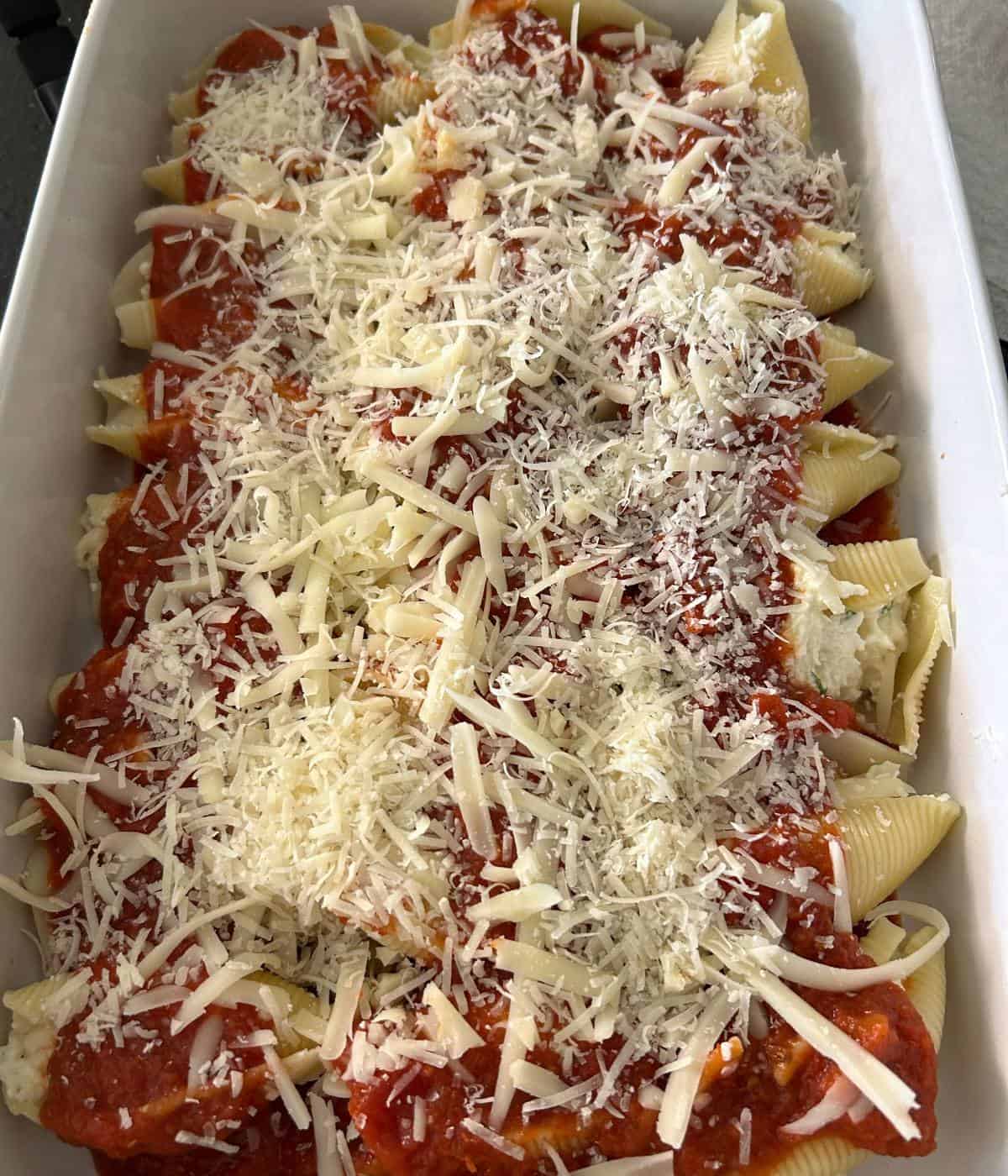 Stuffed shells topped with sauce and cheese.