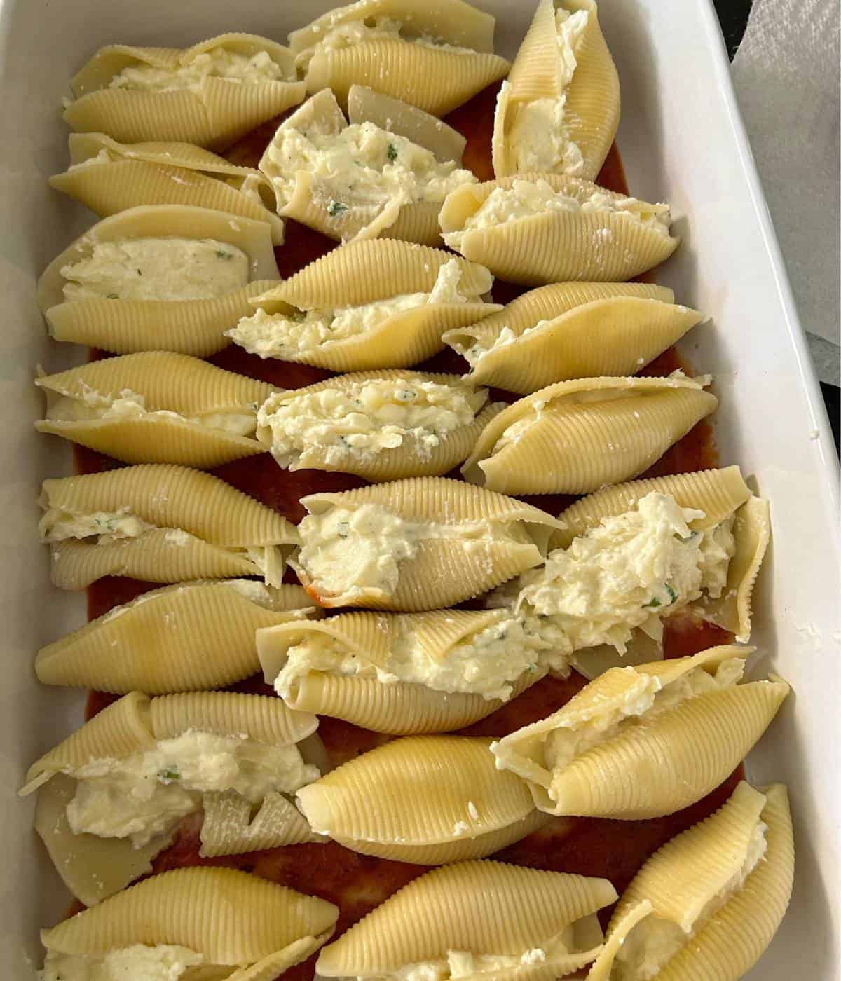 Stuffed shells in casserole dish.