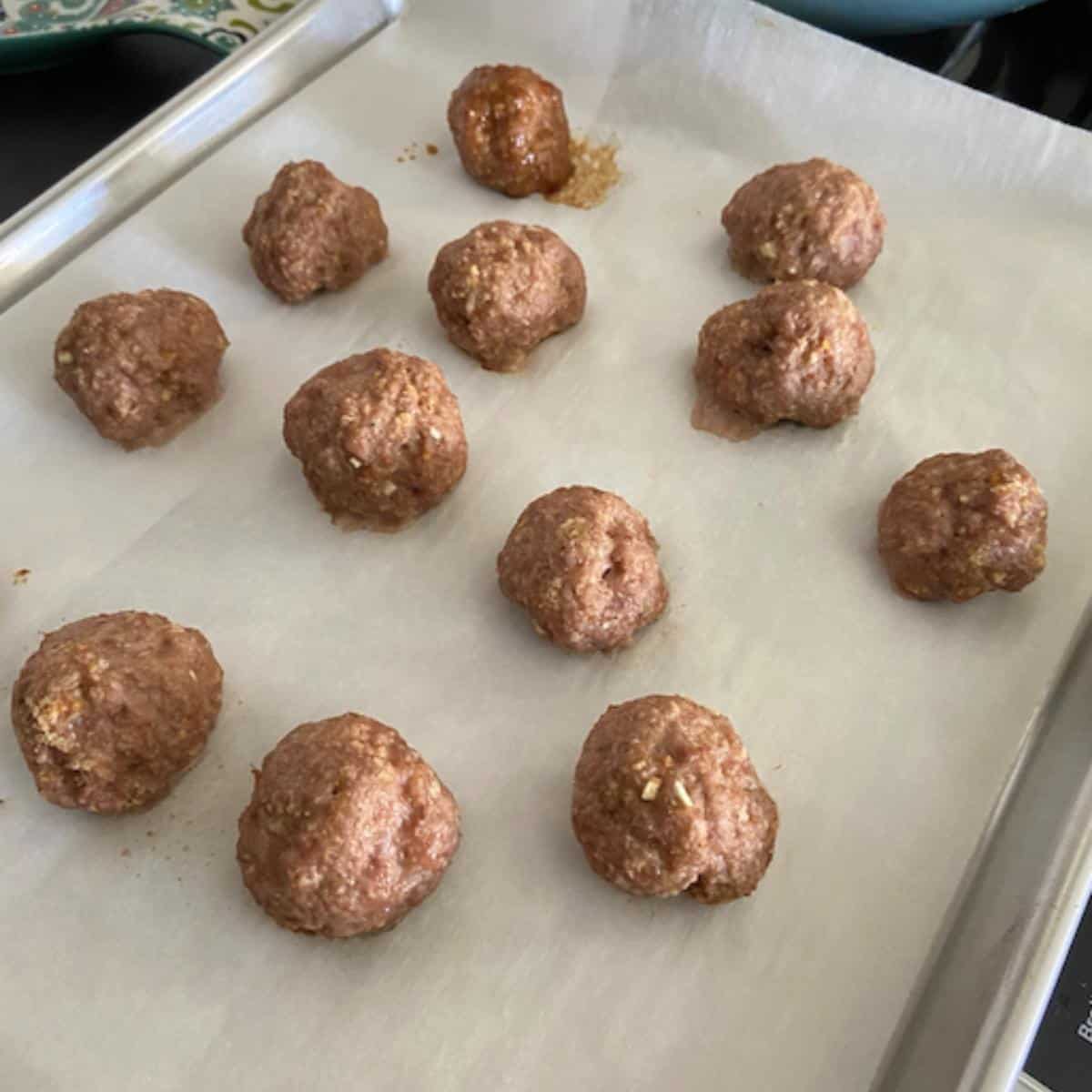 Asian Meatballs baked on cookie sheet.