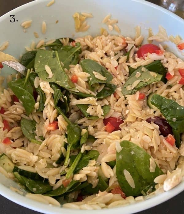 orzo greek pasta salad mixed together in bowl