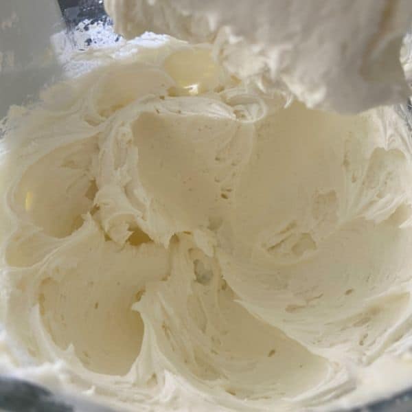 whipped buttercream frosting in glass KitchenAid bowl