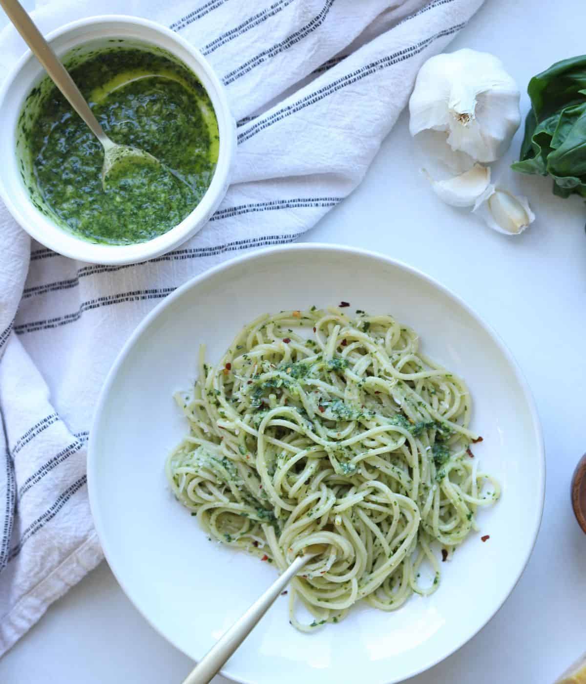 overhead view of bowl of pesto and pasta tossed in pesto