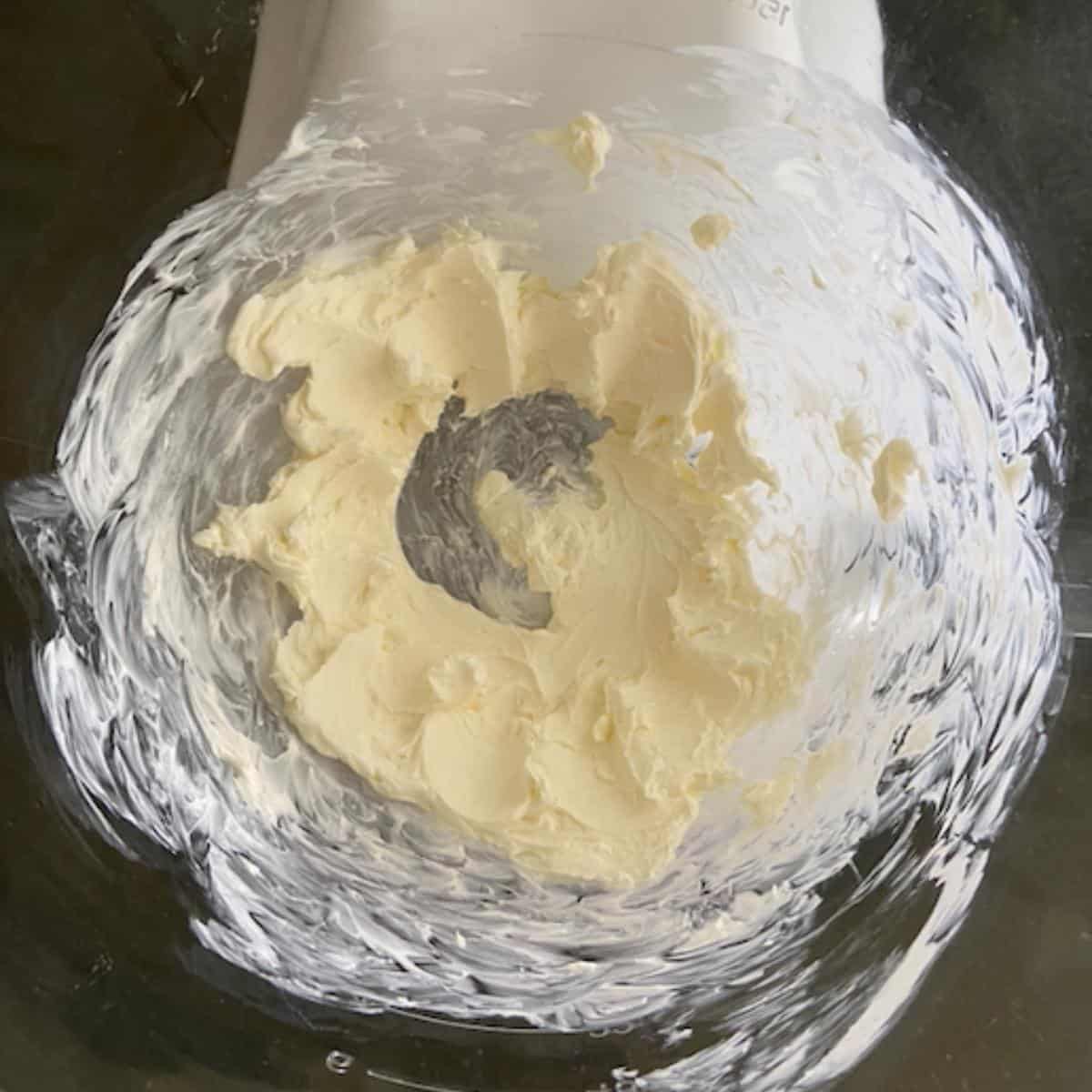 Whipped cream cheese in stand mixer bowl.