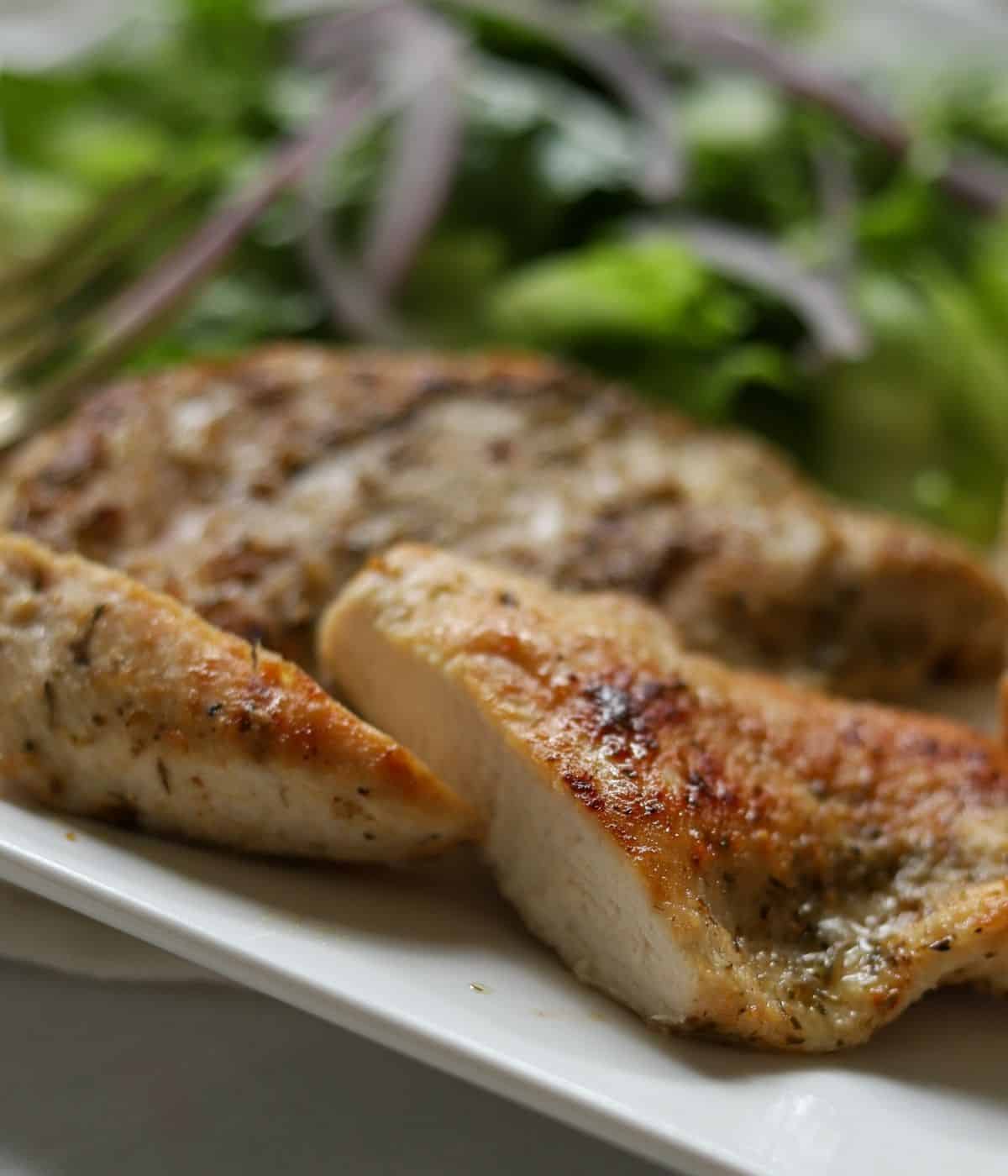 up close view of sautéed chicken breast sliced in half