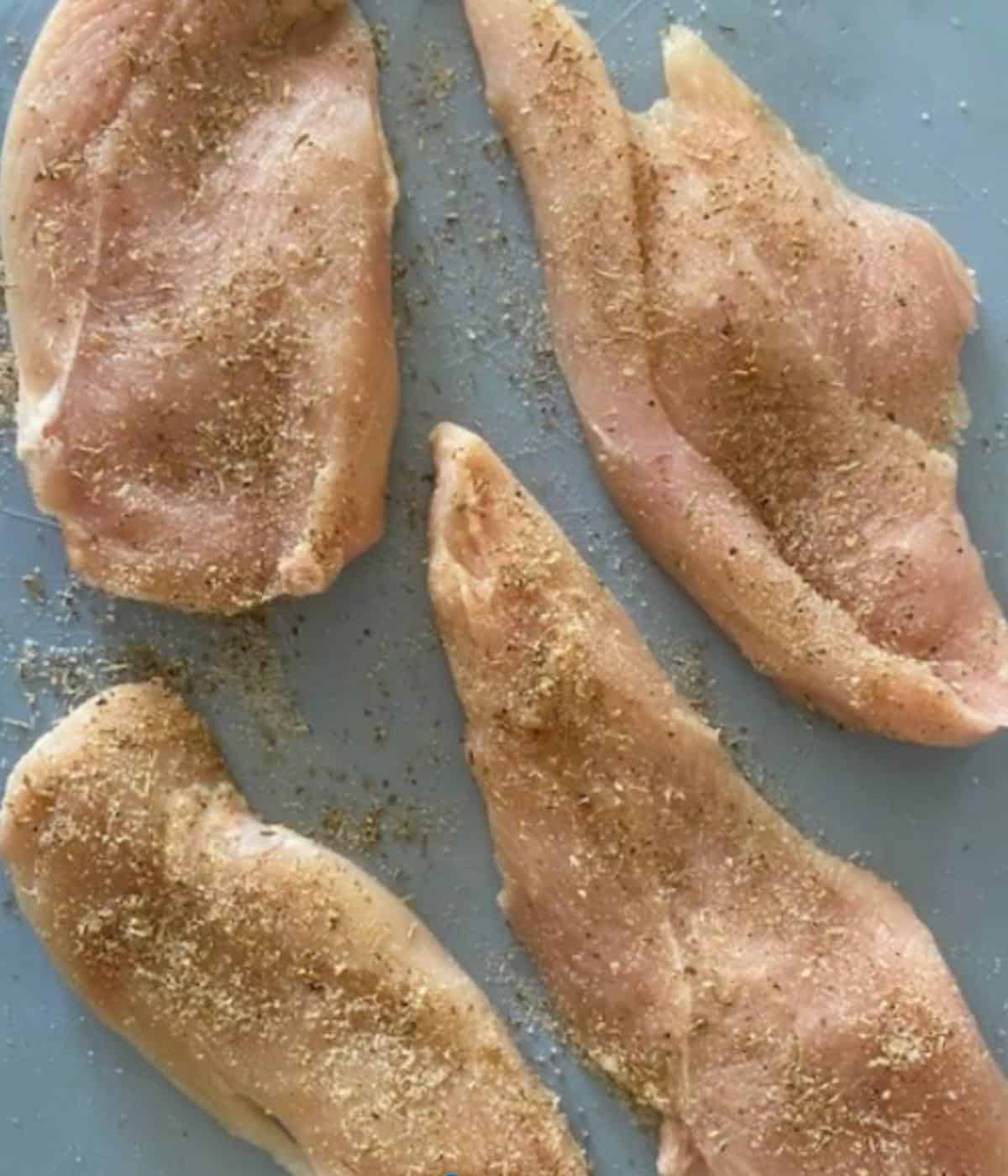 Chicken breast sliced into thin breasts and seasoned.