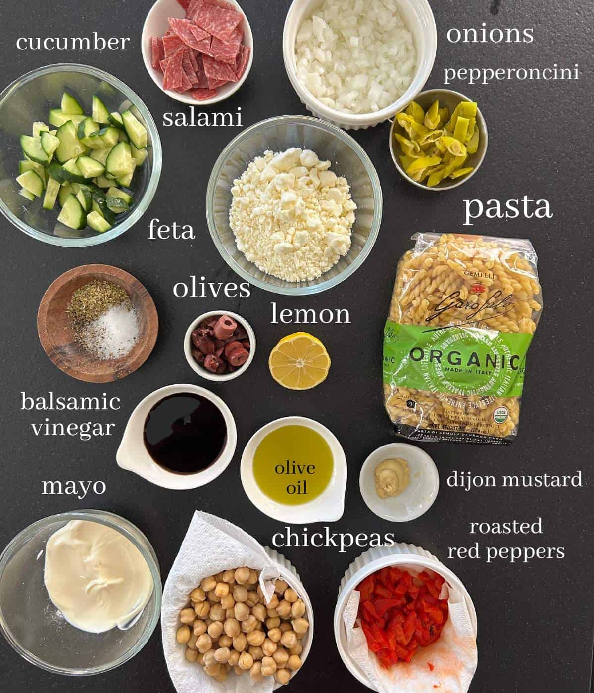Ingredients for pasta salad on counter.