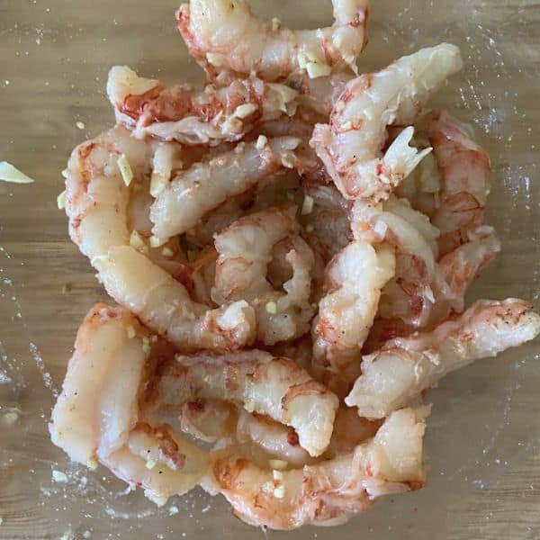 shrimp in glass bowl with garlic and seasoning