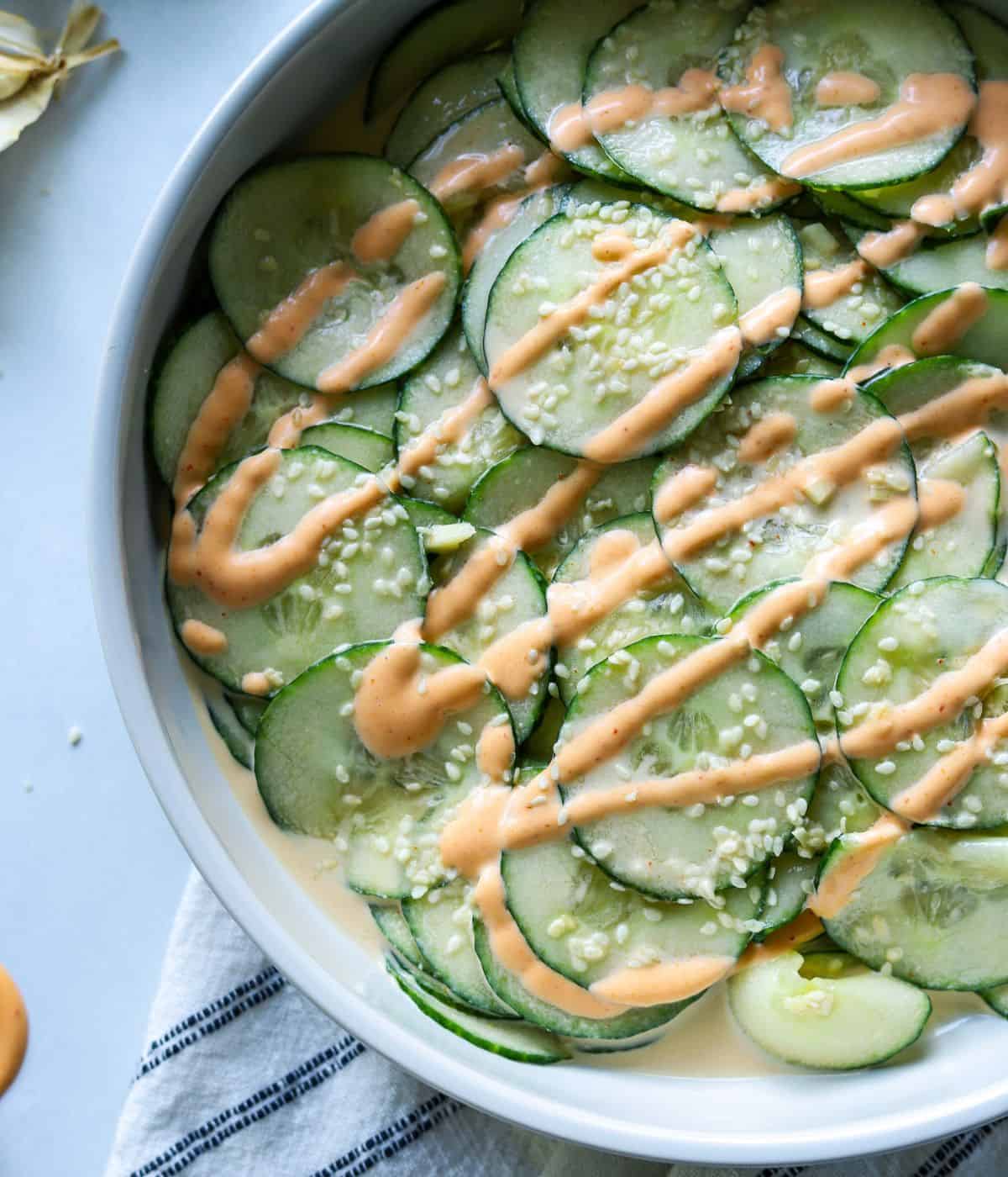 spicy cucumber salad topped with sriracha mayo