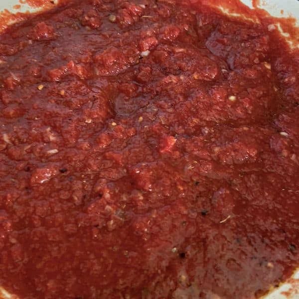 crushed tomatoes added to create sauce
