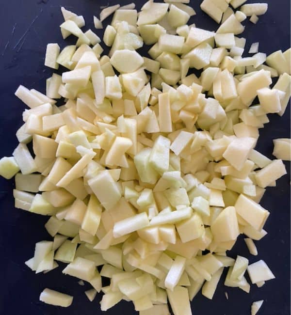chopped up apples on cutting board