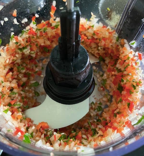 vegetables and herbs inside food processor finely chopped