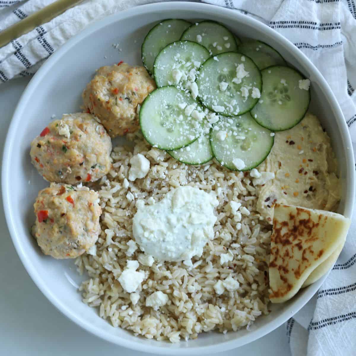 chicken kofta rice bowl with pita bread, cucumber, rice, hummus and tzatziki