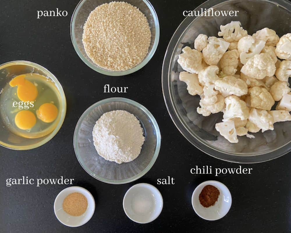 panko cauliflower ingredients with text on black countertop