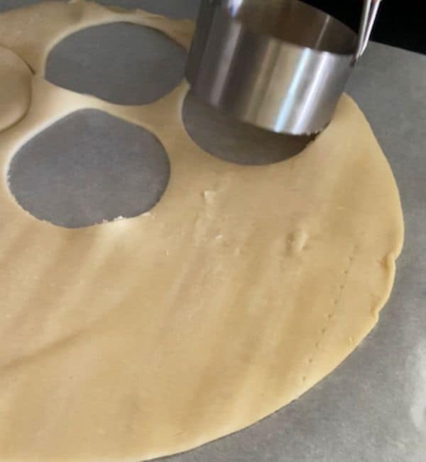 biscuit cutter cutting pie crust into circles