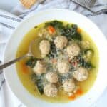 italian wedding soup in a bowl with spoon