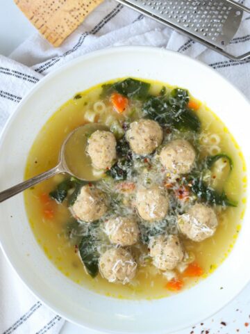 italian wedding soup in a bowl with spoon